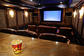 luxury custom home theater with wall lighting sconce's, custome theater seating and projection screen